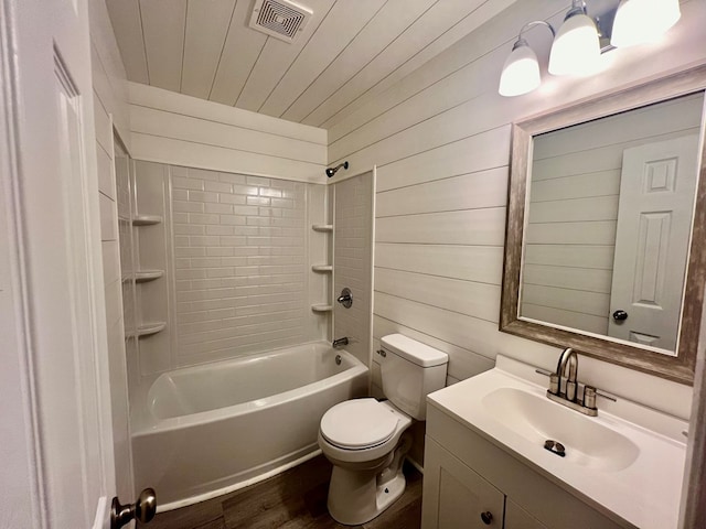 full bathroom featuring wood walls, wood-type flooring, toilet, vanity, and tiled shower / bath