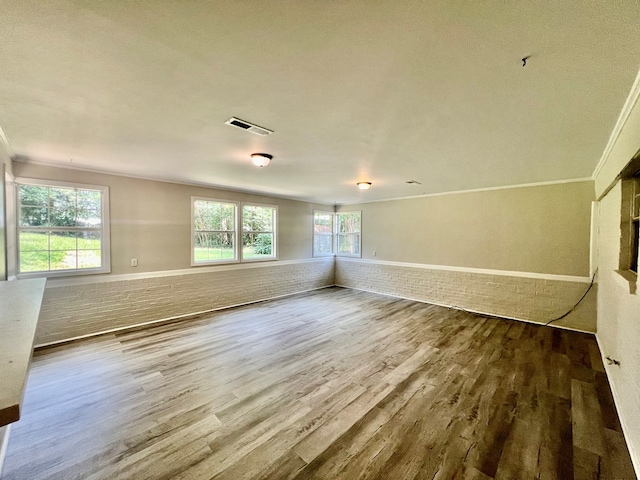 unfurnished room with crown molding and hardwood / wood-style floors