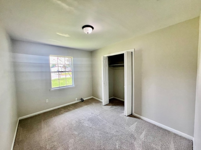 unfurnished bedroom with carpet flooring and a closet