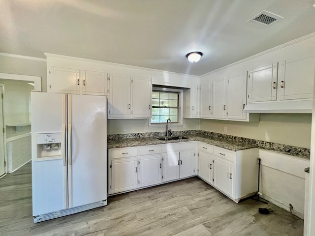 kitchen featuring light wood-type flooring, crown molding, sink, white refrigerator with ice dispenser, and white cabinets