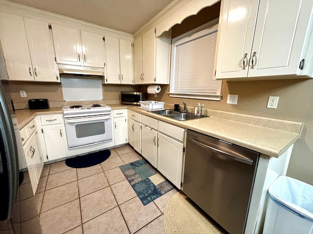 kitchen with sink, light tile patterned floors, a textured ceiling, appliances with stainless steel finishes, and white cabinetry