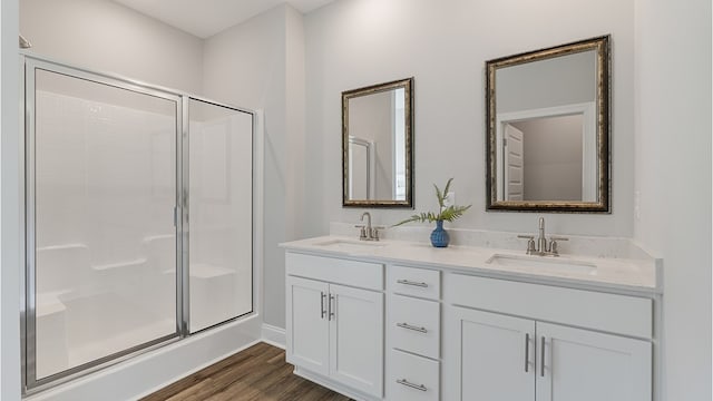 110 Creekridge St, Headland, AL 36345 - full bathroom featuring a stall shower, wood finished floors, double vanity, and baseboards
