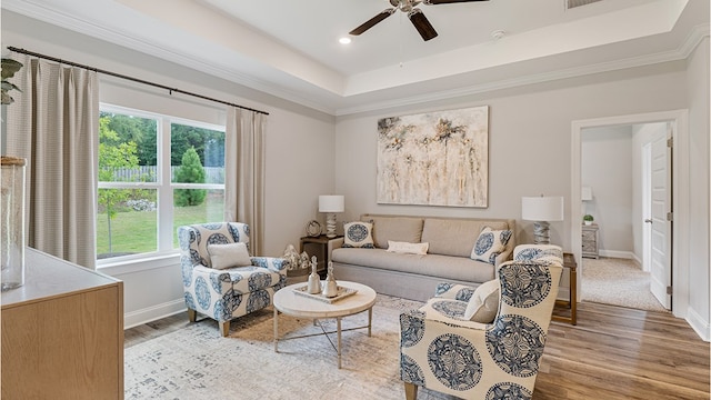 110 Creekridge St, Headland, AL 36345 - living area featuring ceiling fan, wood finished floors, baseboards, a tray ceiling, and crown molding