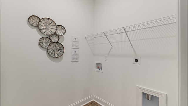 110 Creekridge St, Headland, AL 36345 - laundry room featuring hookup for a washing machine, electric dryer hookup, baseboards, and wood finished floors
