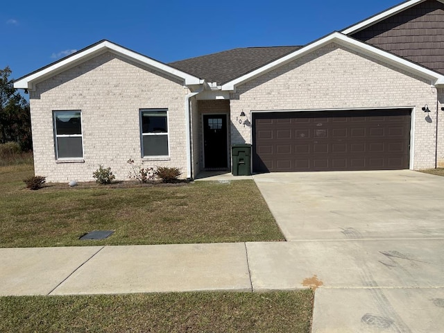 view of front of home with a front lawn and a garage