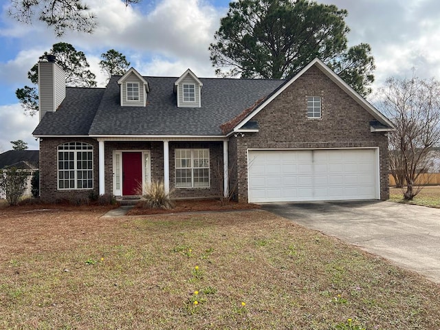 view of front of house with a garage and a front lawn