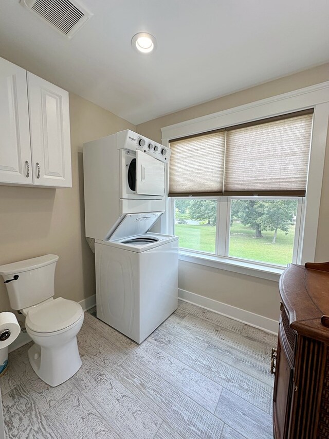 washroom featuring stacked washer / dryer