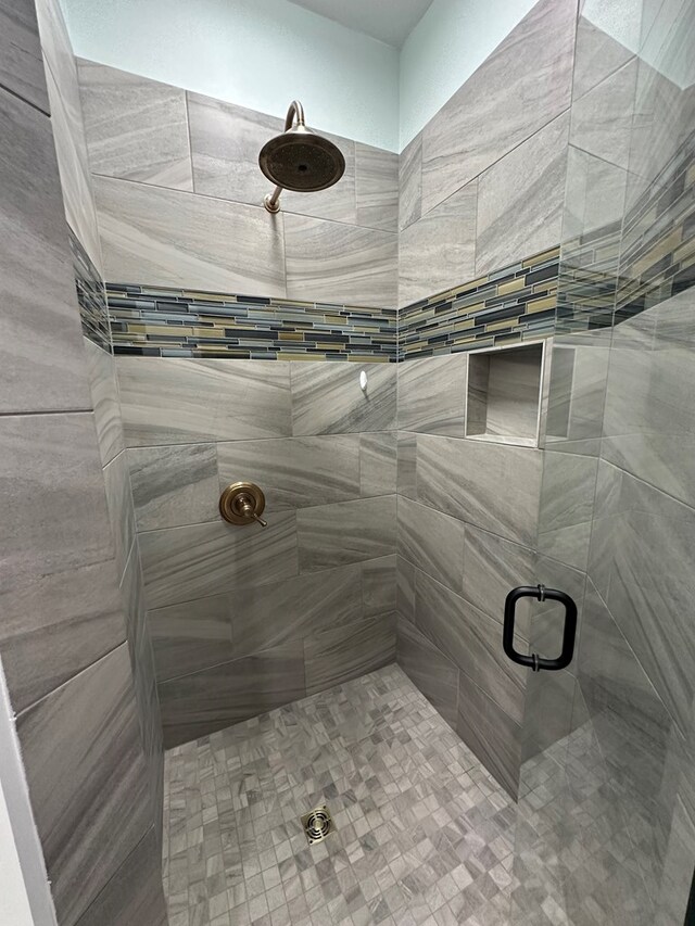 bathroom featuring a shower with shower door