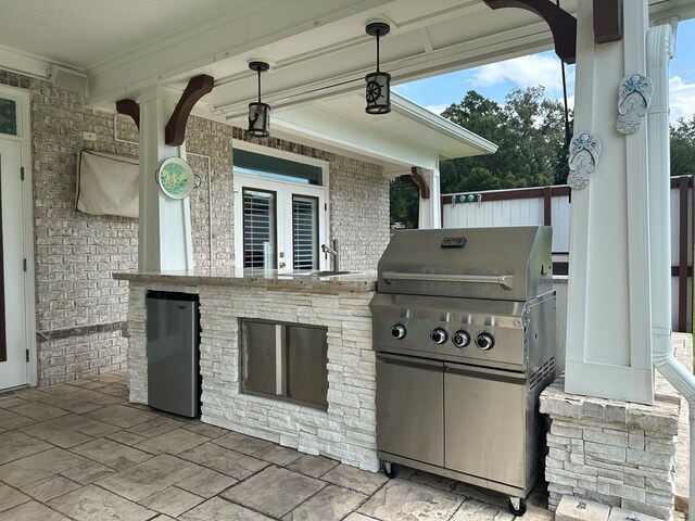 view of patio featuring grilling area, sink, and exterior kitchen