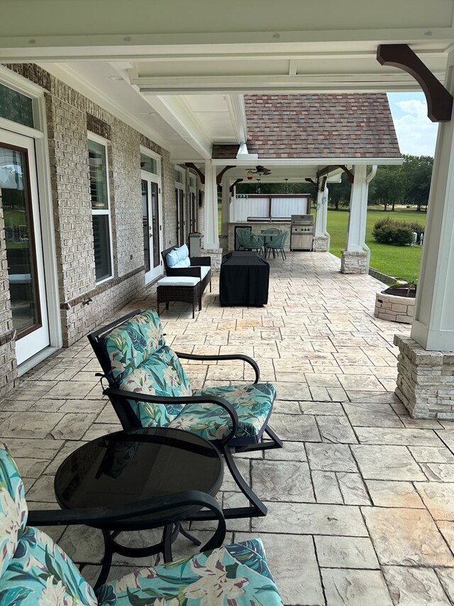 view of patio with grilling area, ceiling fan, and an outdoor living space