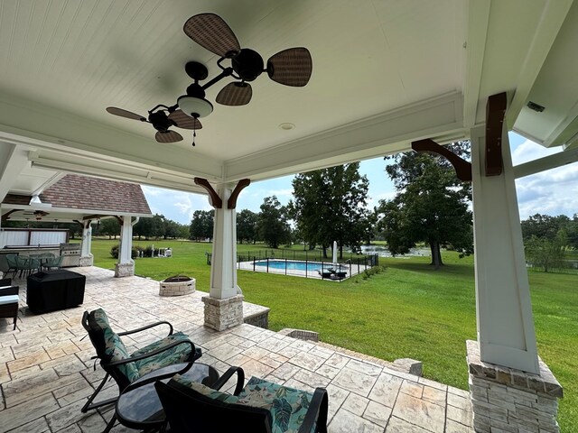 view of patio / terrace featuring ceiling fan and an outdoor fire pit