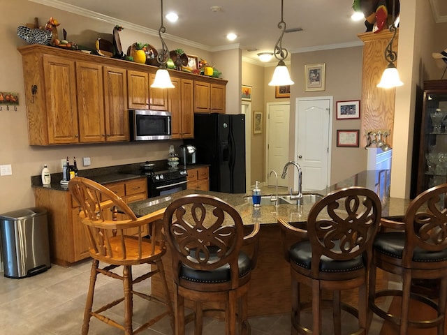 kitchen featuring black appliances, decorative light fixtures, crown molding, and sink