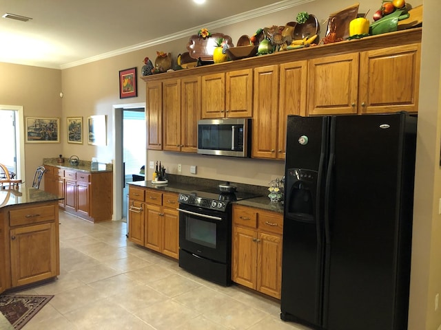 kitchen featuring crown molding, plenty of natural light, light tile patterned flooring, and black appliances