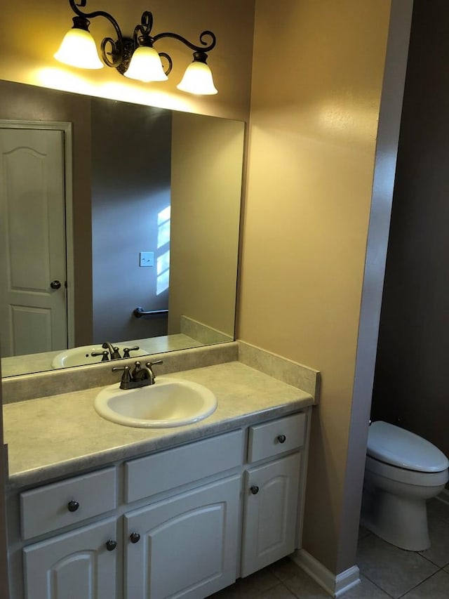 bathroom with tile patterned floors, vanity, and toilet