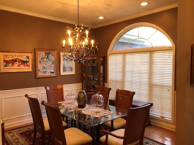 dining room featuring a notable chandelier, dark hardwood / wood-style floors, and ornamental molding