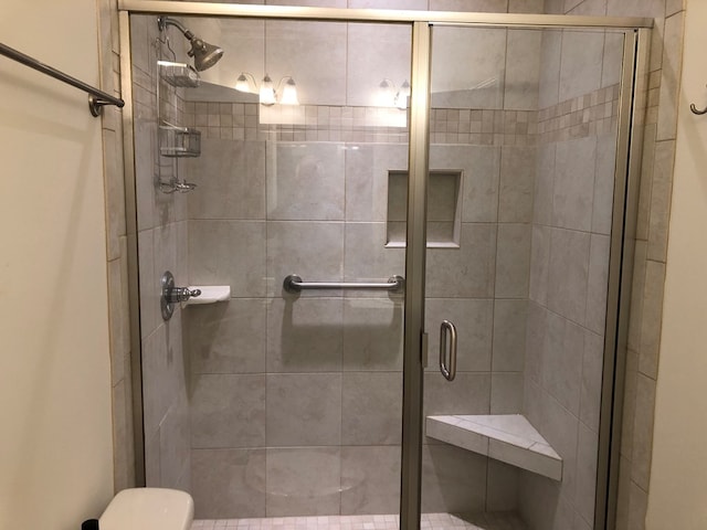 bathroom with toilet and walk in shower