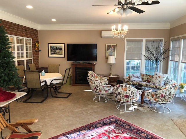 living room featuring ceiling fan with notable chandelier, crown molding, light tile patterned floors, and a fireplace