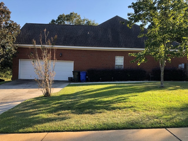 view of property exterior with a lawn and a garage