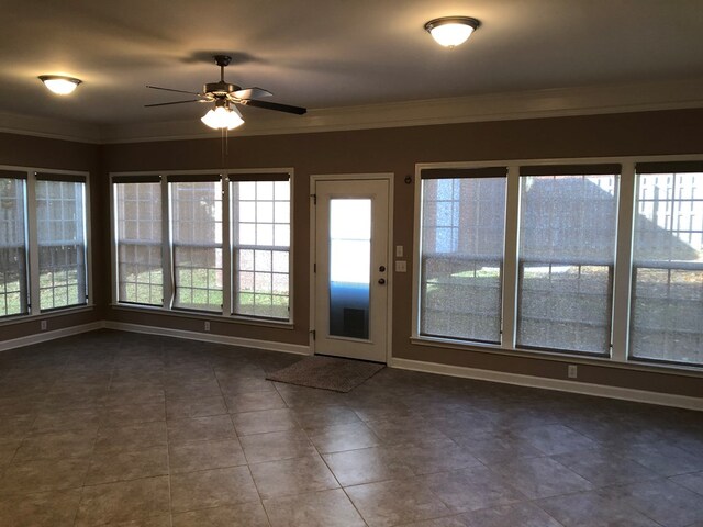 unfurnished sunroom with ceiling fan