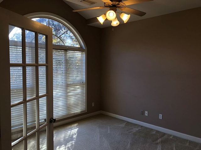 spare room with ceiling fan and carpet