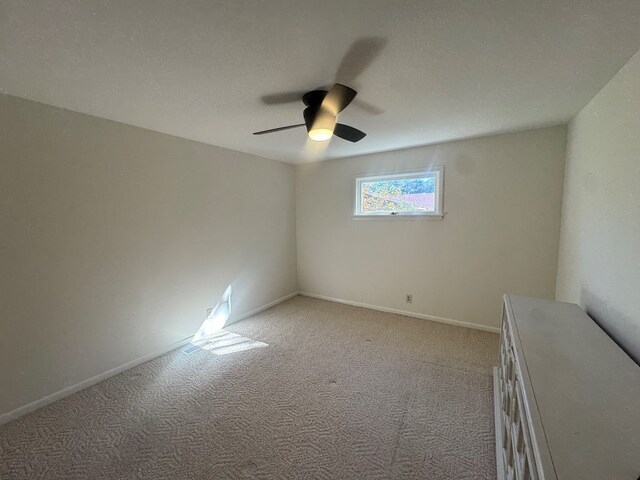 carpeted empty room with ceiling fan