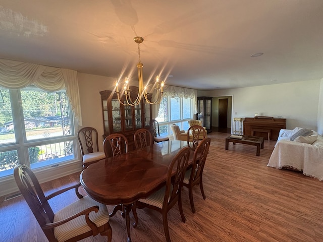 dining area with a chandelier and hardwood / wood-style flooring