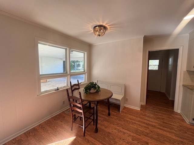 dining space featuring radiator heating unit, dark hardwood / wood-style flooring, and ornamental molding