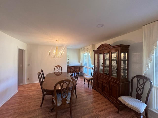 dining area featuring dark hardwood / wood-style floors and a notable chandelier