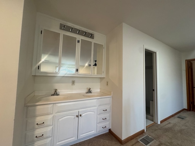 bar with white cabinets, sink, and carpet