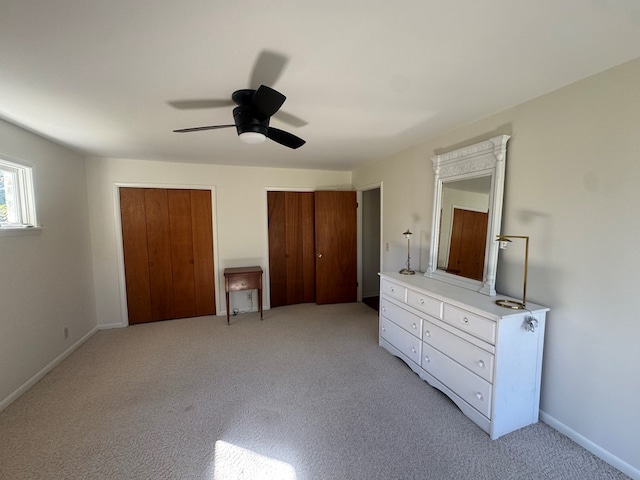 unfurnished bedroom with ceiling fan and light carpet