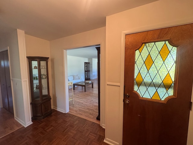 entrance foyer featuring dark parquet floors