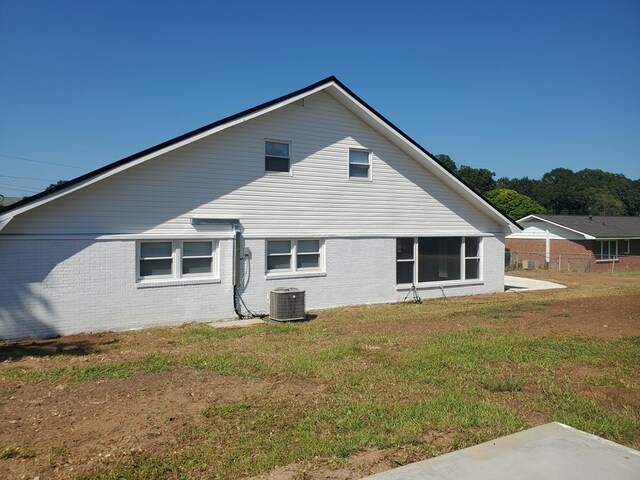 rear view of property featuring a yard