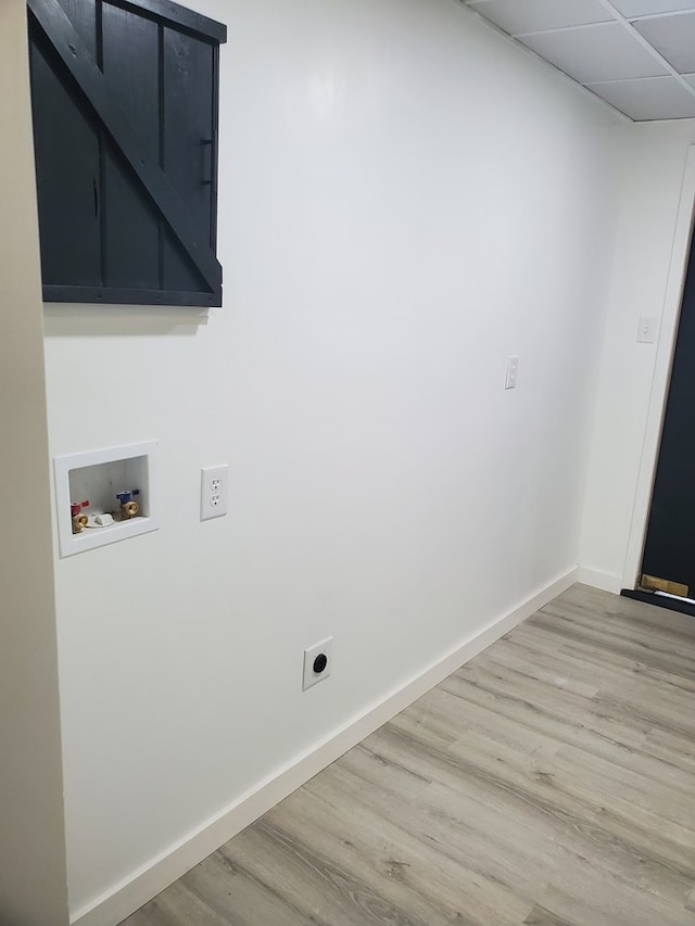 laundry room featuring electric dryer hookup, light hardwood / wood-style floors, cabinets, and hookup for a washing machine