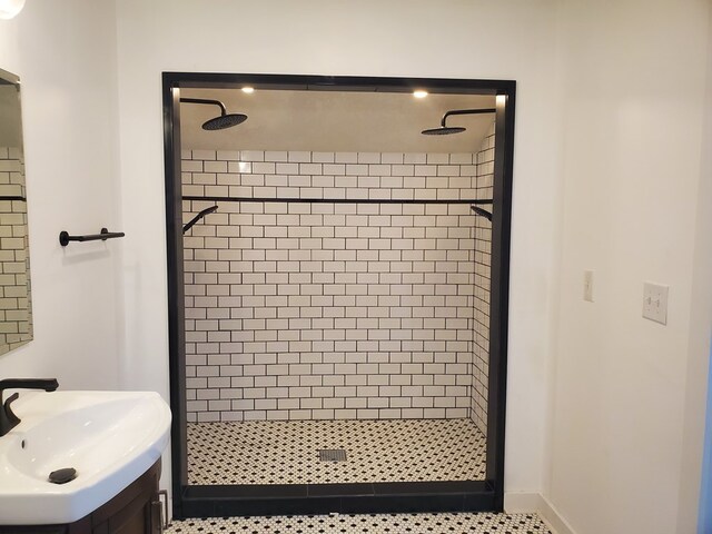 bathroom featuring a tile shower and sink