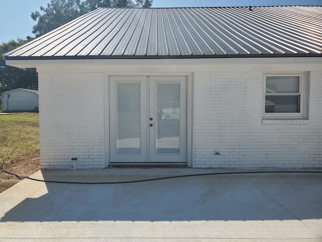 property entrance featuring a patio area and french doors