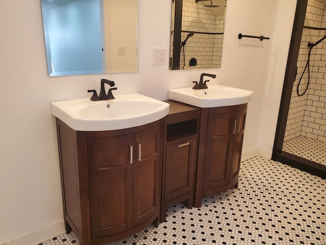 bathroom with tiled shower, vanity, and tile patterned floors