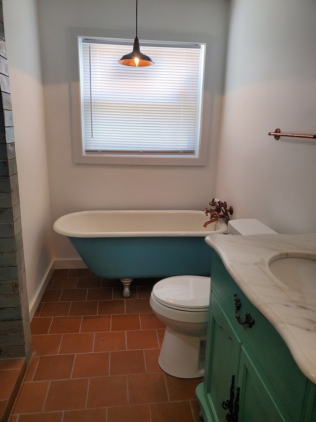 bathroom with toilet, vanity, a tub to relax in, and tile patterned floors