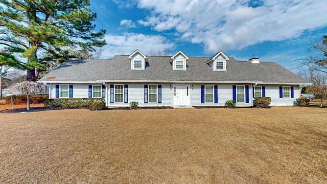 cape cod home featuring a front yard