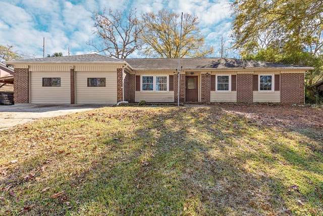 ranch-style home featuring a garage and a front lawn