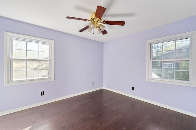 spare room with dark hardwood / wood-style floors and ceiling fan