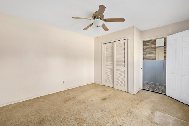 unfurnished bedroom with light colored carpet, ceiling fan, and a closet