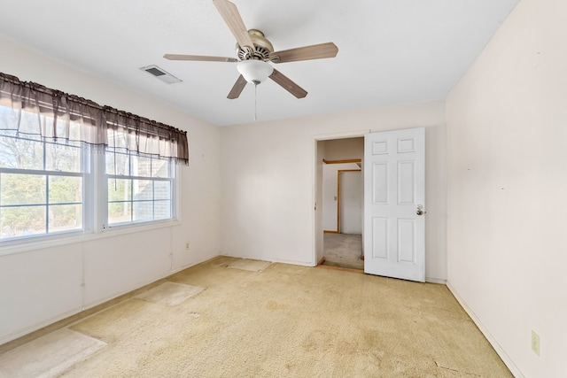 unfurnished bedroom featuring light carpet and ceiling fan