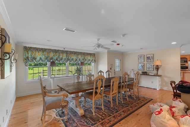 dining room with a wealth of natural light, crown molding, ceiling fan, and light hardwood / wood-style floors