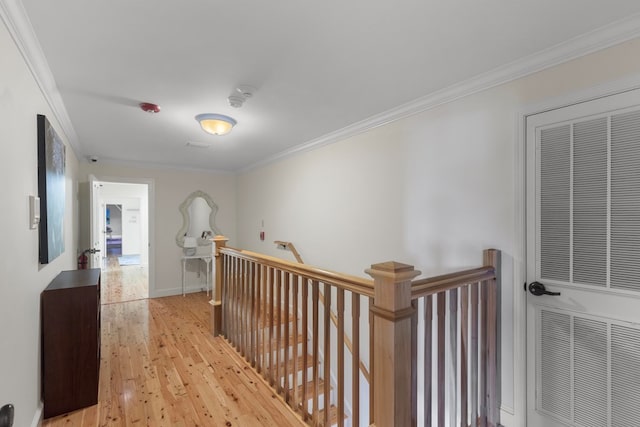 corridor featuring light wood-type flooring and ornamental molding