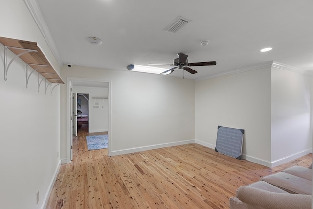 unfurnished living room with ceiling fan, light hardwood / wood-style floors, and crown molding