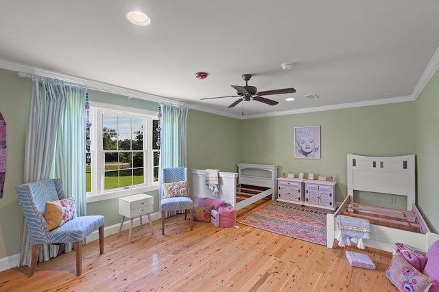 bedroom featuring ceiling fan, hardwood / wood-style floors, and crown molding