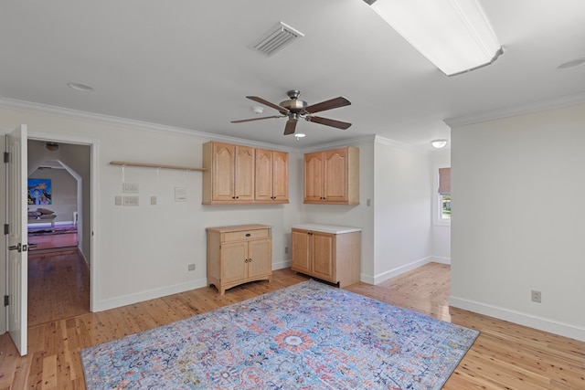 kitchen with ceiling fan, light brown cabinets, ornamental molding, and light hardwood / wood-style flooring