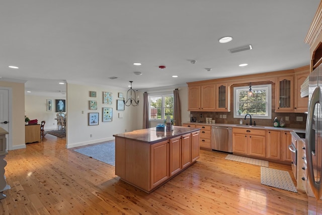 kitchen with dishwasher, a center island, light wood-type flooring, and plenty of natural light