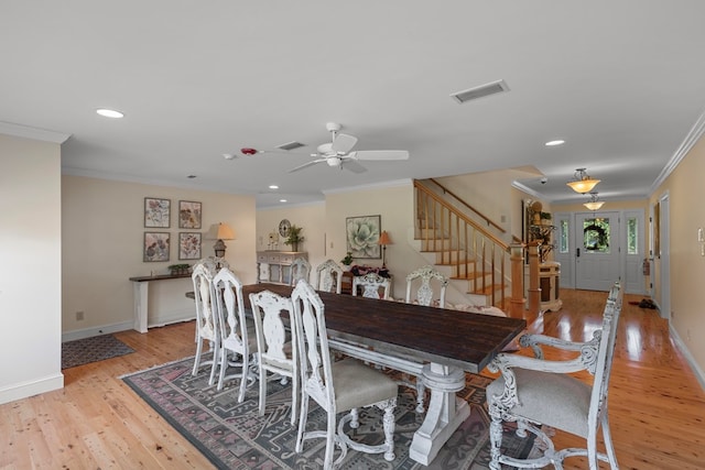 dining room with crown molding, ceiling fan, and light hardwood / wood-style floors