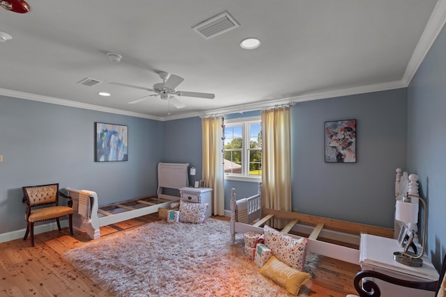 interior space featuring light wood-type flooring, ceiling fan, and ornamental molding